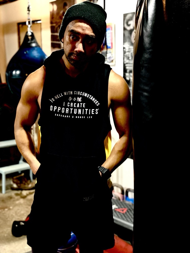 Coach Ed in the gym beside a heavy bag